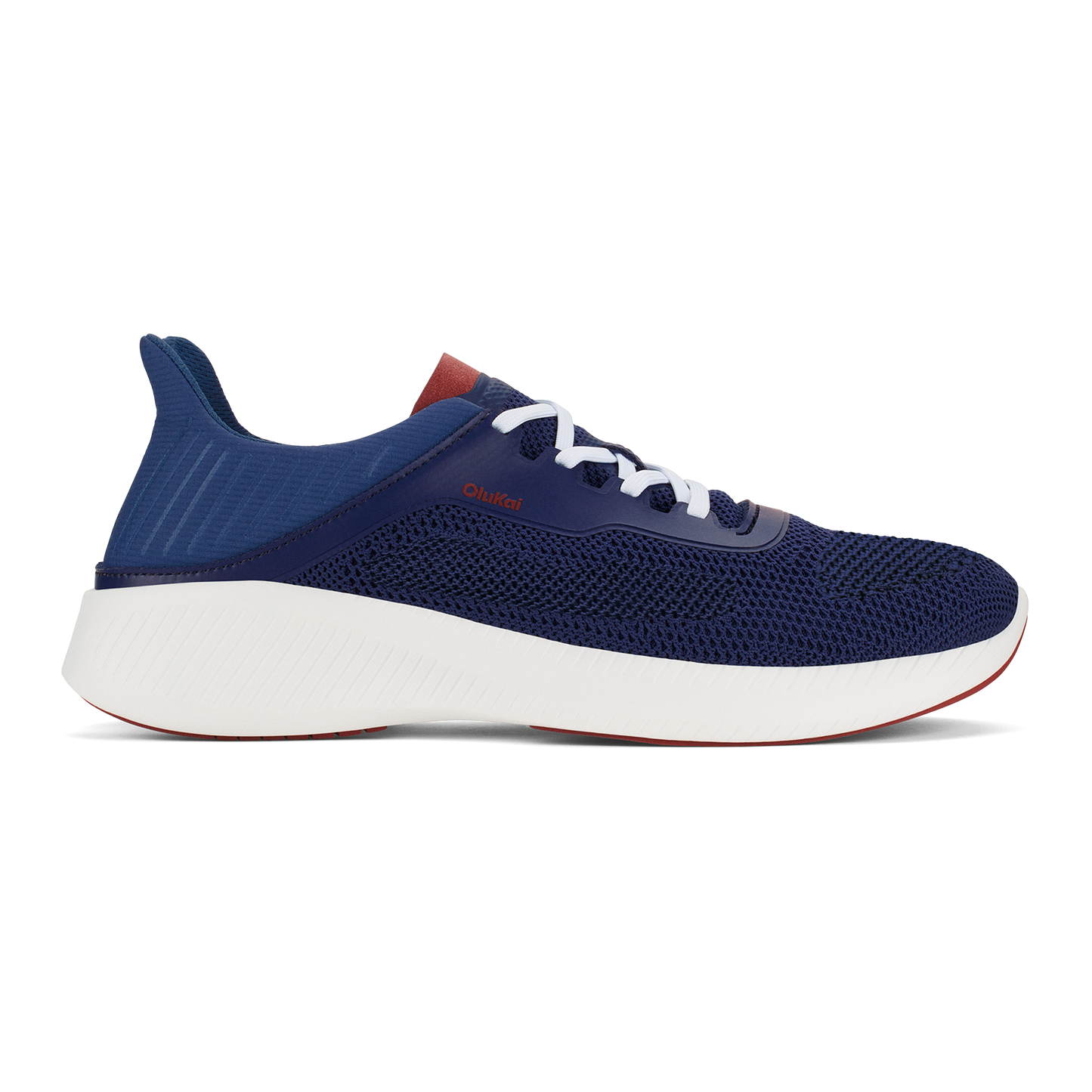 A navy blue low-top athletic sneaker with a thick white midsole, white laces, and a small reddish-brown accent on the heel and near the laces, viewed from the side.