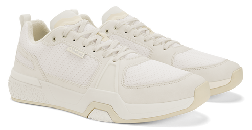 Beige sneakers with white laces and sole.