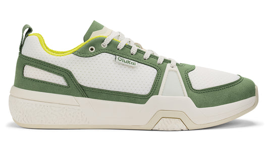 Low top white and green sneaker with logo.