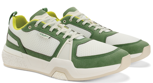 A pair of olive green and white athletic shoes with white laces and yellow lining.