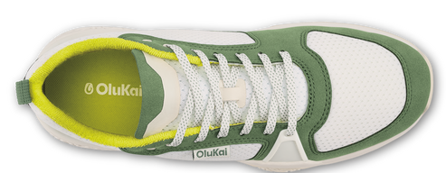 Overhead view of a green and white sneaker with white laces and a yellow interior.