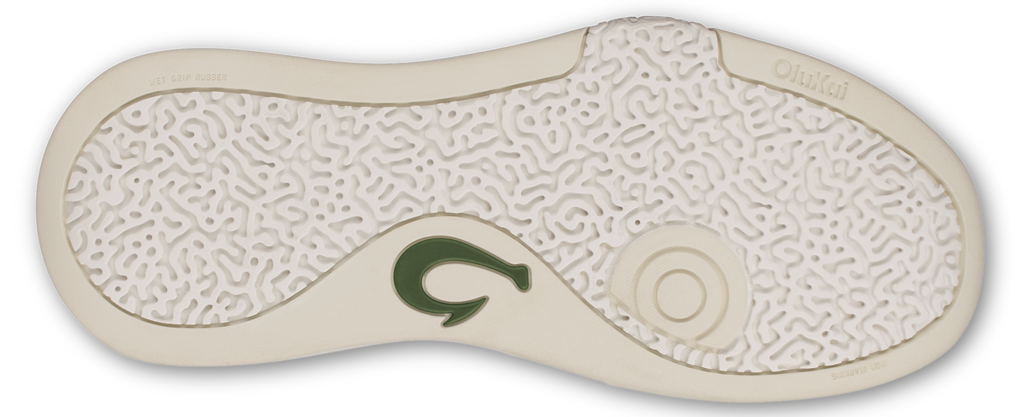 The sole of a sandal with a textured pattern and a green logo.
