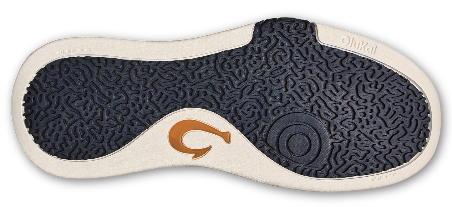 A shoe sole with a textured blue pattern and a golden logo.