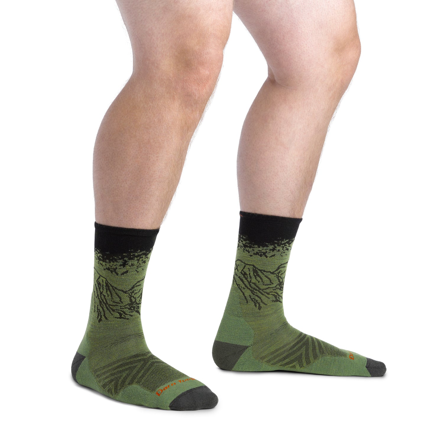 Person wearing green socks with a mountain design and black cuff and toe.