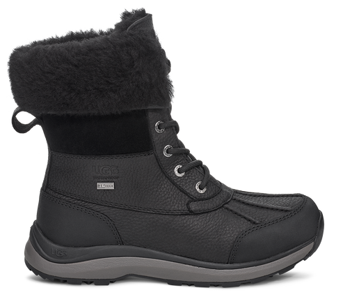 Black, lace-up, waterproof winter boot with faux fur trim.