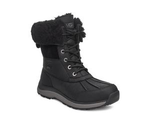 Black winter boot with fur cuff and laced closure.