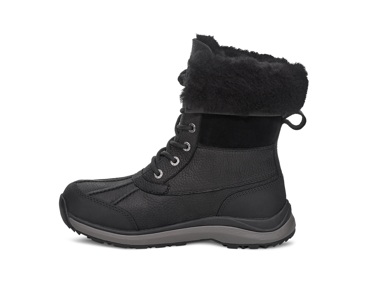 Black mid-calf boot with lacing, faux fur collar, and dark gray sole.
