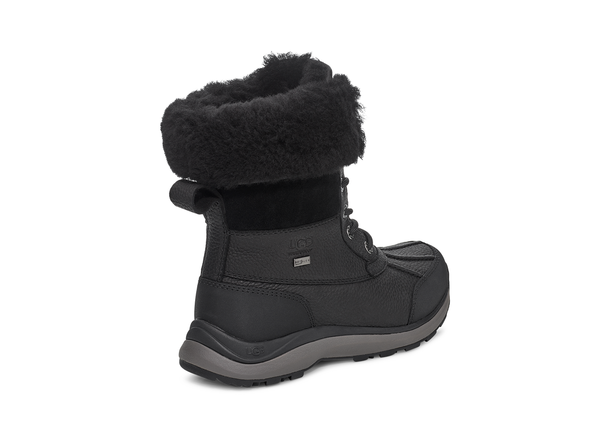 Black winter boot with fur trim.