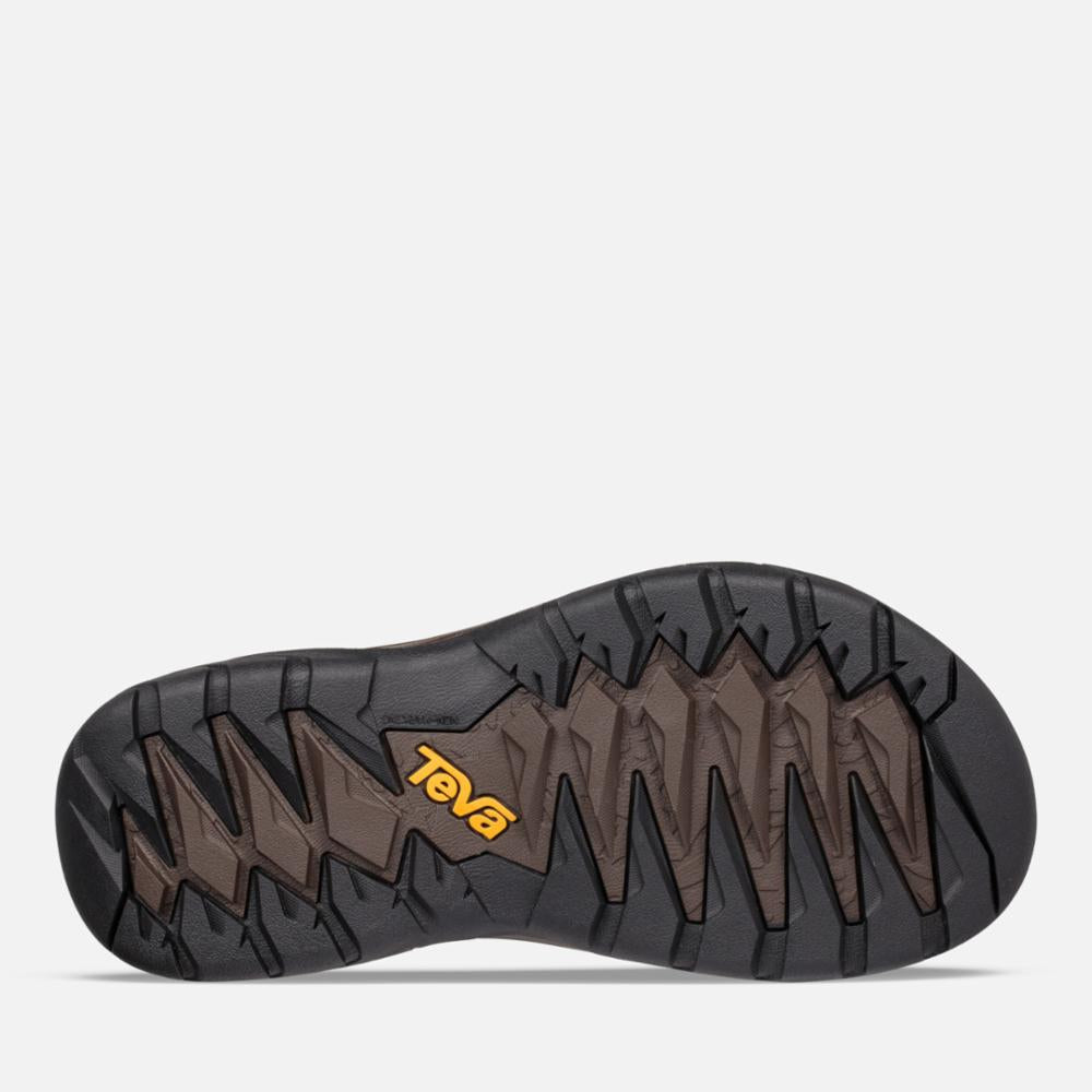 Teva brand dark colored sandal sole with raised tread pattern and brand marking.