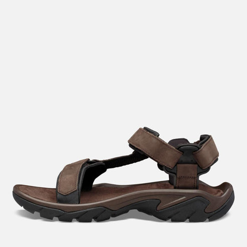 Side-view of a brown sandal with dark-colored sole and straps.