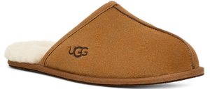 A tan slipper with a white wool lining and the letters UGG on the side.