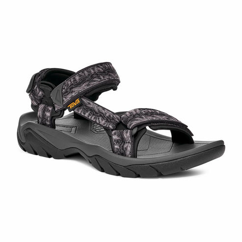 A black and gray sandal with adjustable straps and a black sole, with a small orange label.