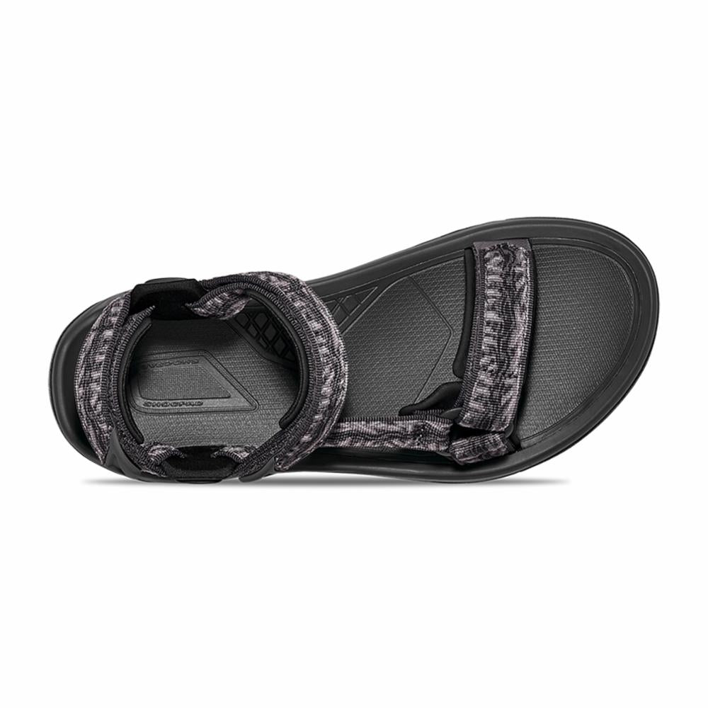 Black sandal with patterned straps, seen from above.