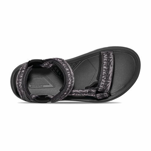 Black sandal with patterned straps, seen from above.