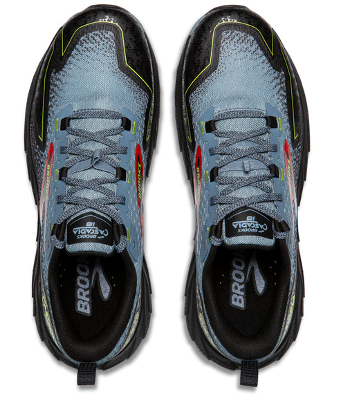 Top-down view of two trail running shoes. The shoes are blue, gray, black, red and neon green, with dark gray laces.  'Brooks Cascadia 16' is printed on the tongue of each shoe.