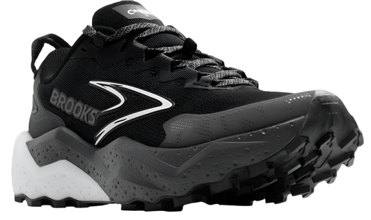 Low-cut running shoe in black with white accents, 'BROOKS' text on the side, and textured sole.