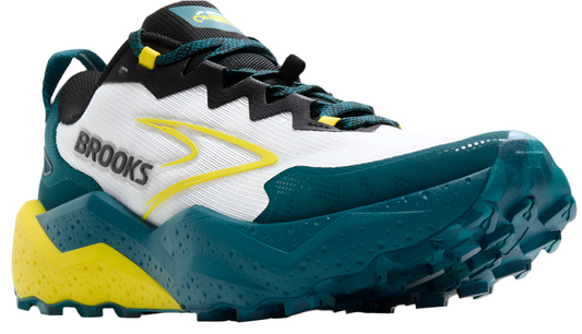 Trail running shoe with a white body, black and green trim, a yellow logo and accents, and a teal sole.