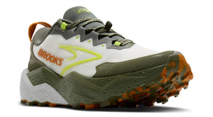 A white, green, and orange trail running shoe with a lugged outsole and the word "BROOKS" printed on the side.