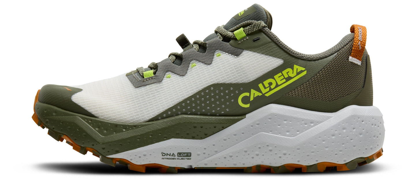A side view of a running shoe with white and green coloring, gray laces, and yellow branding that reads "CALDERA".
