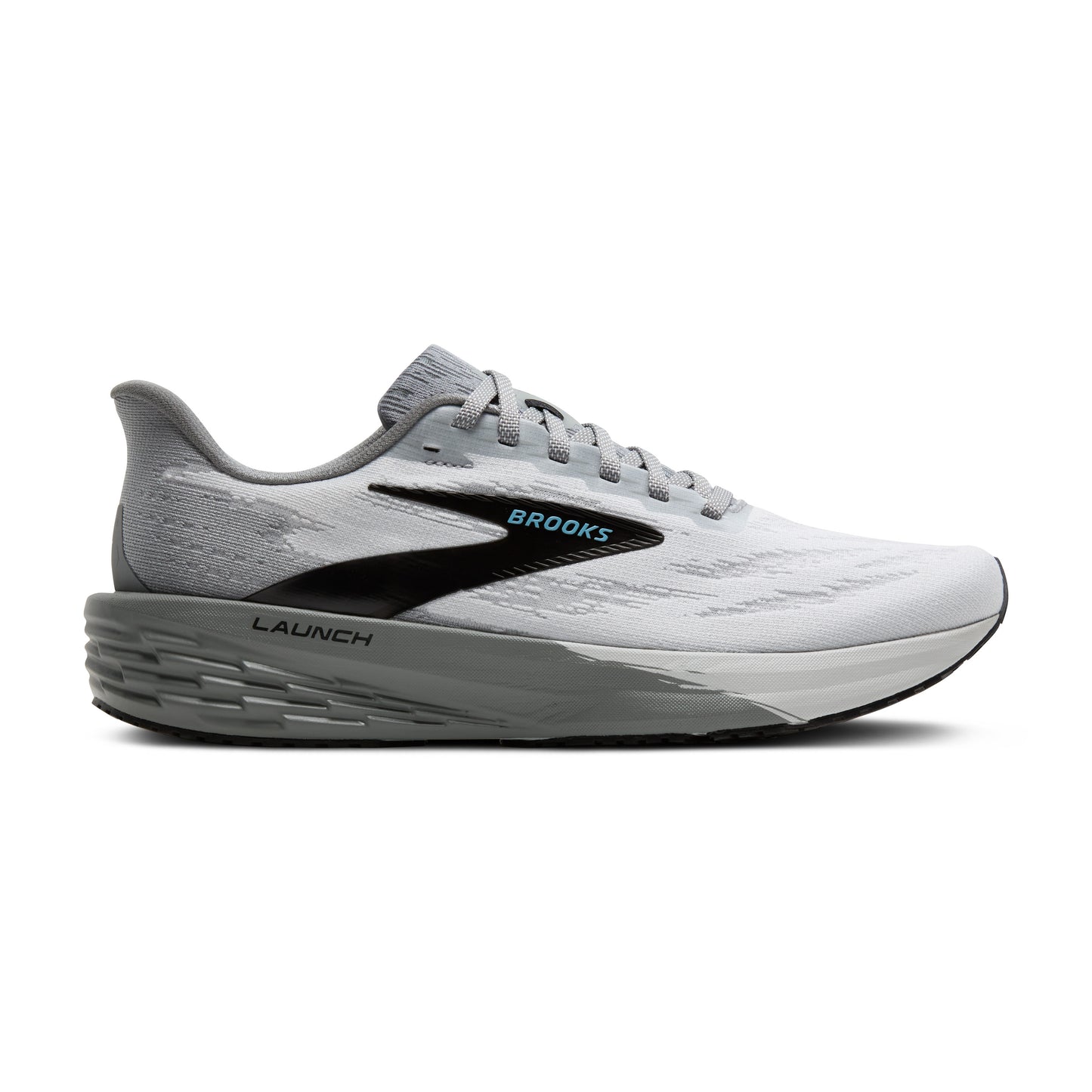 A running shoe that is white with gray soles and a black swoosh that has the word "BROOKS" in blue.