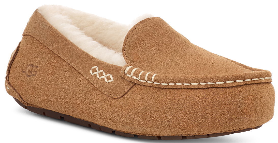 Tan suede moccasin slipper with faux fur lining and decorative stitching.