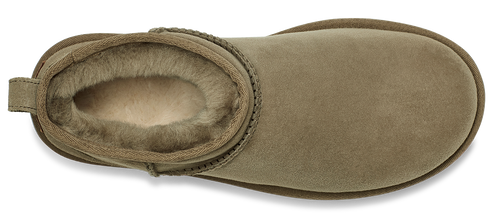 A tan Ugg boot with a tan trim and light-colored fur lining.