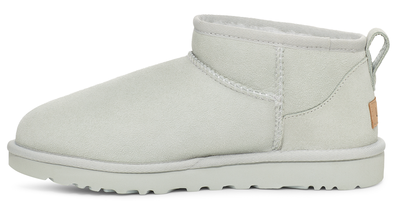 White ankle-high boot with a low heel, white sole and pull tab.