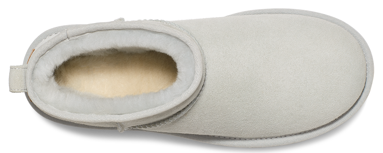 A white, rounded slipper with a soft lining.