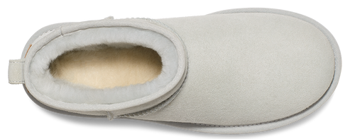 A white, rounded slipper with a soft lining.