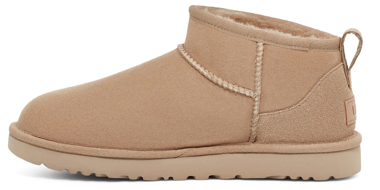 Tan ankle boot with interior fur lining and pull tab on the heel.