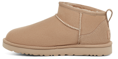 Tan ankle boot with interior fur lining and pull tab on the heel.