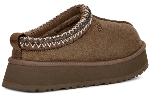 Brown slipper with a thick sole and a decorative trim around the opening.