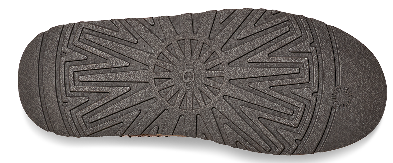 The sole of a shoe with a UGG logo in the center.