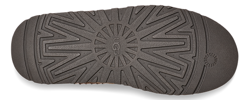 The sole of a shoe with a UGG logo in the center.