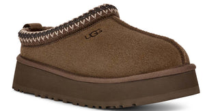 Brown suede-like platform slipper with a decorative knit band around the opening and UGG lettering on the side.