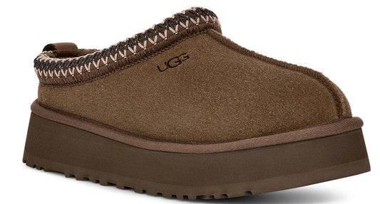 Brown suede-like platform slipper with a decorative knit band around the opening and UGG lettering on the side.