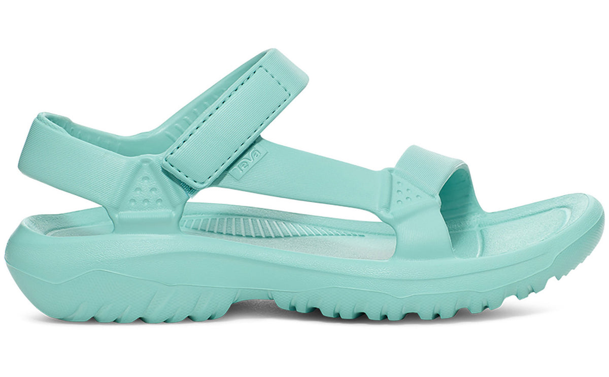 Side view of a light blue sandal with thick adjustable straps and a chunky treaded sole.