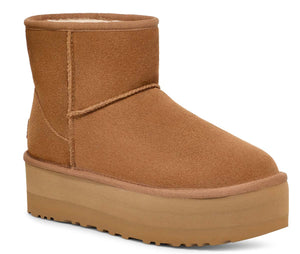 Chestnut-colored short suede platform boot with visible cream lining.