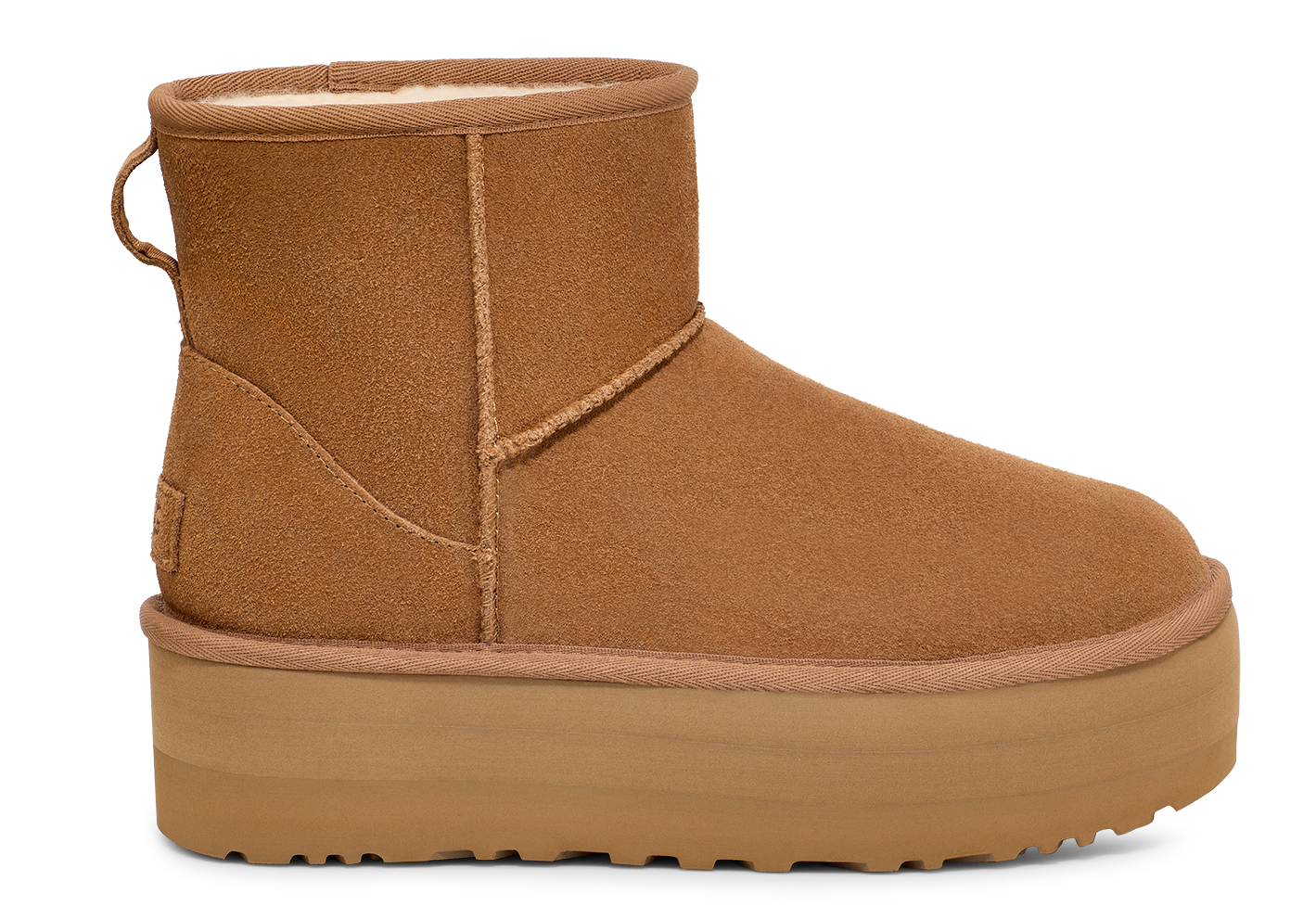 Tan suede ankle boot with a matching platform sole and a fabric loop on the back