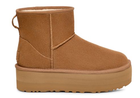 Tan suede ankle boot with a matching platform sole and a fabric loop on the back
