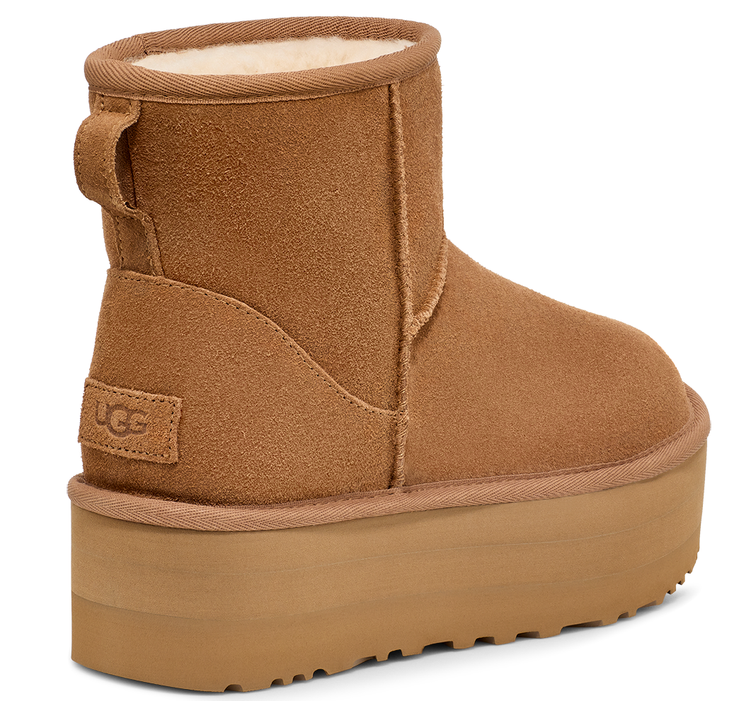 An UGG ankle boot with a tall platform sole and a pull loop on the back.