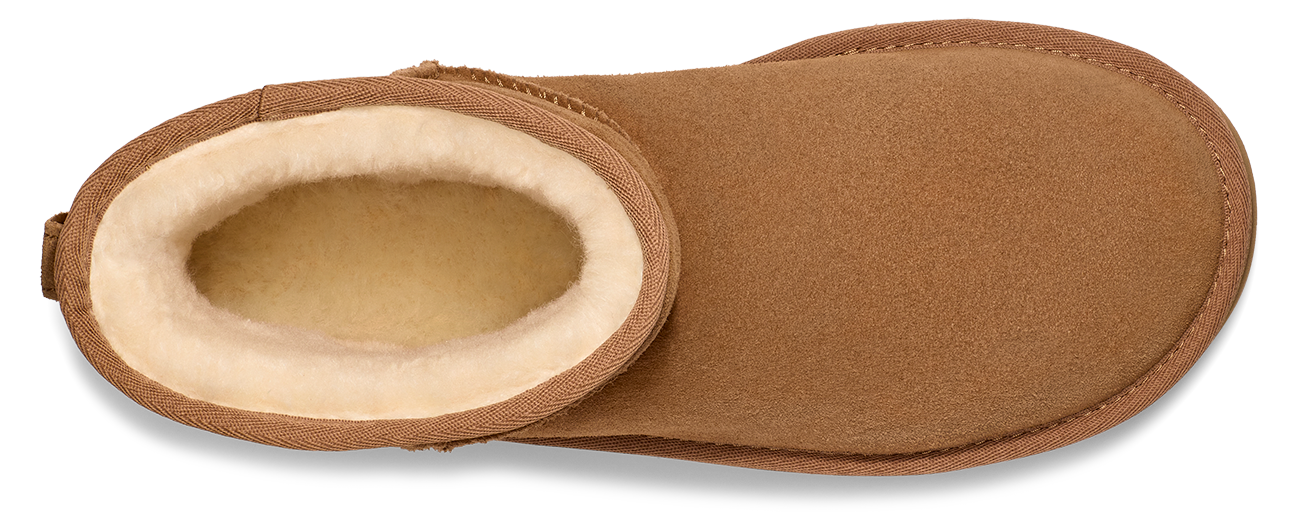 Close-up of a brown, slipper-style shoe with a visible white, fuzzy interior.