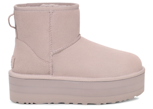 Platform mini boot in pale lavender color, featuring a suede upper and pull tab.