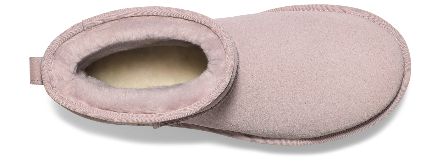 Light pink UGG Tasman slipper with cream-colored shearling lining visible from the top.