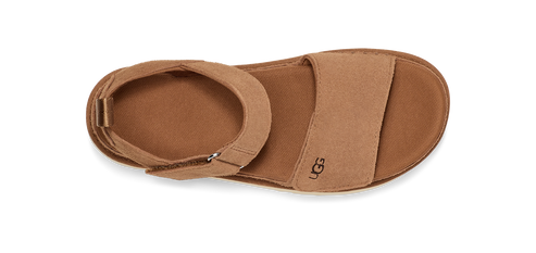 A tan-colored sandal with two wide straps, one around the toes and one around the ankle, and the letters 'UGG' on the side.