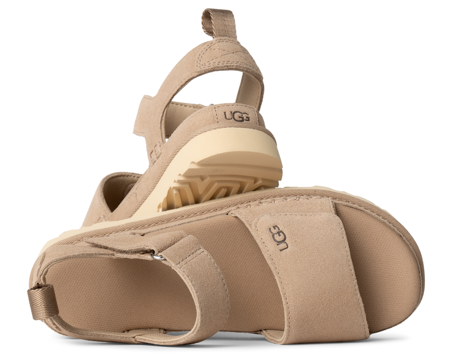 Two tan sandals with elastic back straps and wedge soles, UGG logo visible on the side.