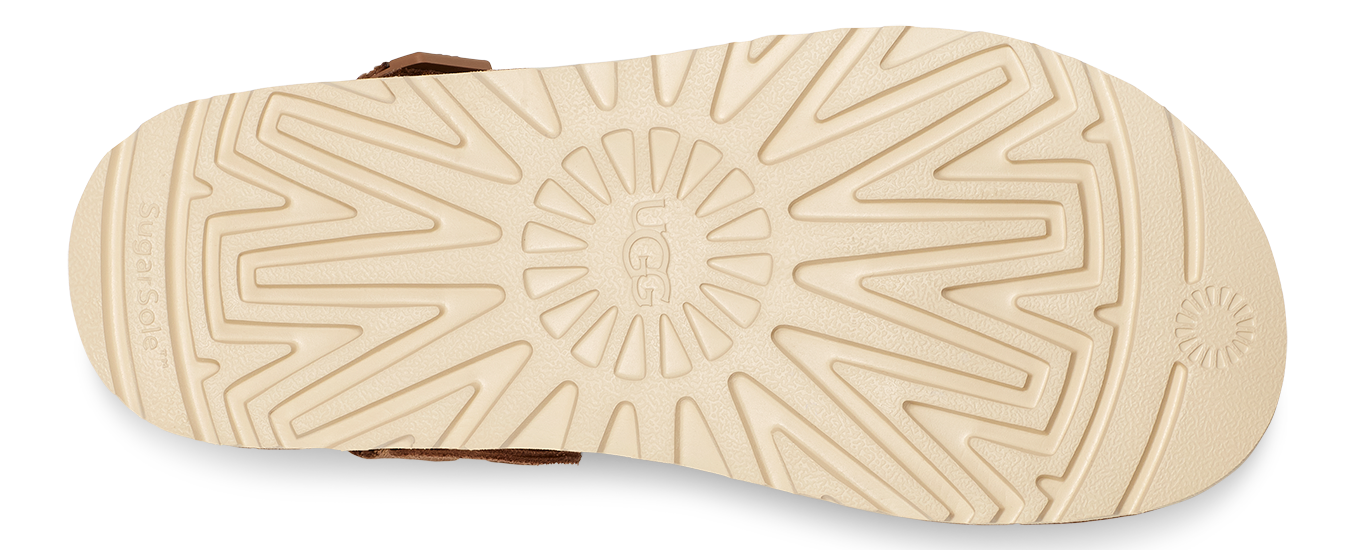 Tan-colored rubber outsole with the brand's logo and geometric traction pattern.
