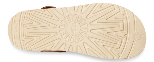 Tan-colored rubber outsole with the brand's logo and geometric traction pattern.