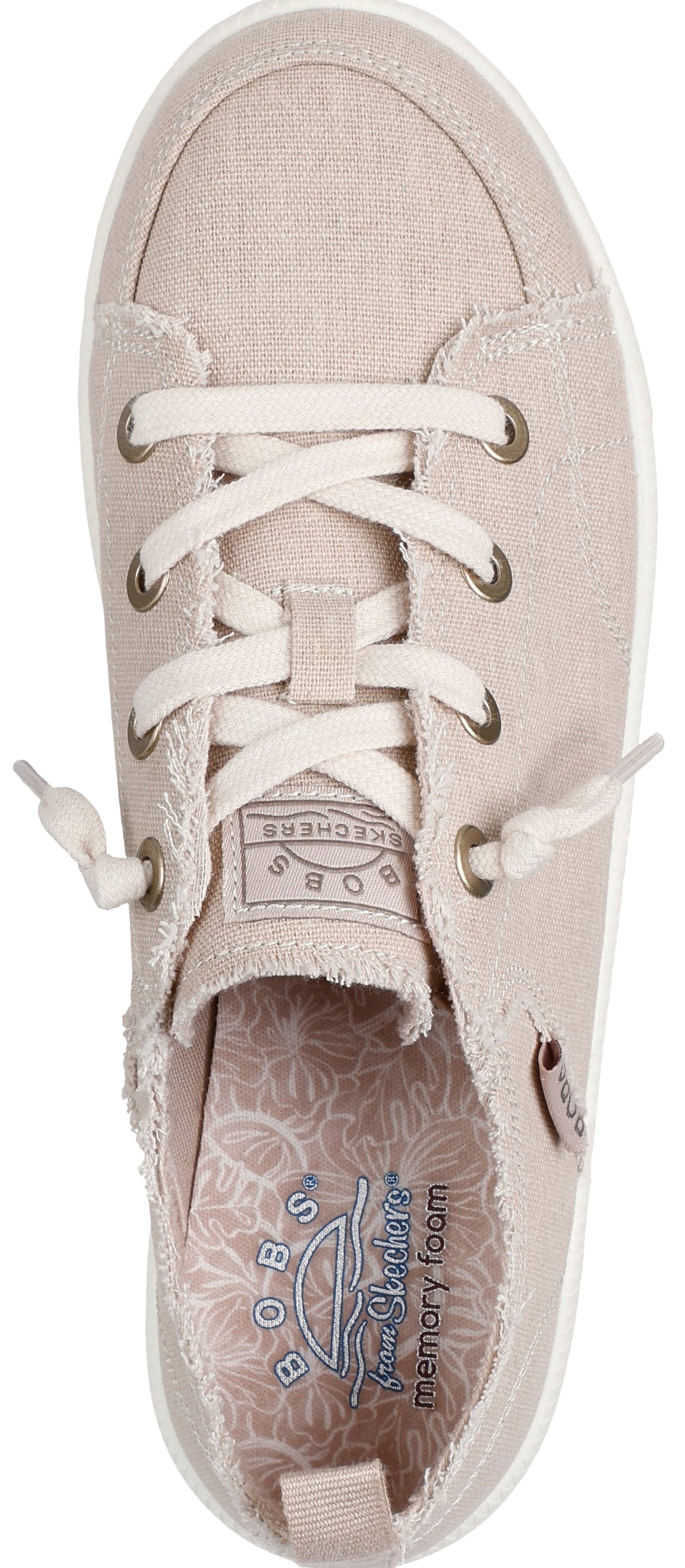 Beige canvas shoe with white laces and frayed edges.