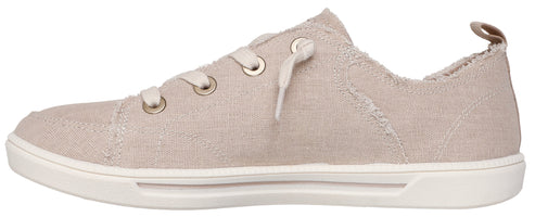 A light beige canvas sneaker with a white sole and off-white laces.